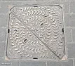 Manhole covers lifting with excess rainfall  |  Assuming the utility company lifts these covers once a year for  "backwards"...