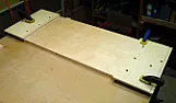 Masking shelf ends to prefinish dadoes - an idea  |  Background:Bookcases, 3/4" ply. Shelves fit into 3/4" x 1/4" dadoes in...