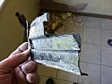 Corrugated tarpaper behind plaster on slightly damp wall?  |  We've just moved, to a house with an old (early 18th century, probably) ...