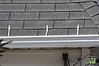 Gutter Straps over shingles? |  I had my gutters replaced and they attached them to the roof with metal...