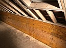 Tie to attach joist to beam above it